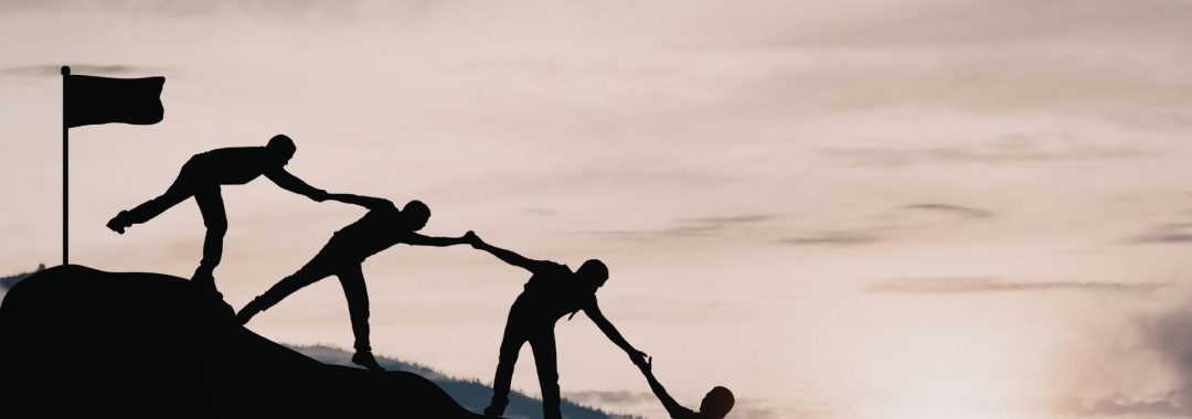 A group of people silhouetted against a sunrise, representing teamwork and connection at the Fiji Educators Conference 2026.