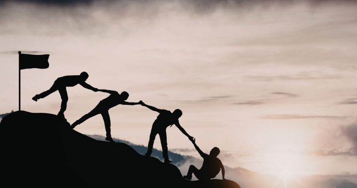 A group of people silhouetted against a sunrise, representing teamwork and connection at the Fiji Educators Conference 2026.